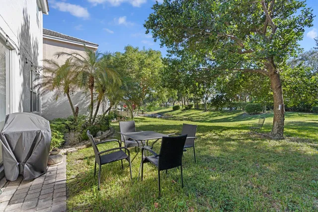 a backyard of a house with table and chairs