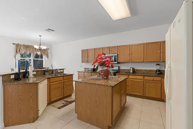 a kitchen with stainless steel appliances granite countertop a sink and dishwasher