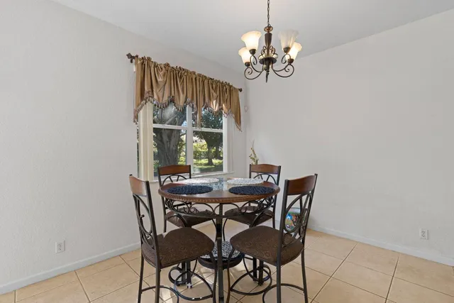 a view of a dining room with furniture wooden floor and chandelier