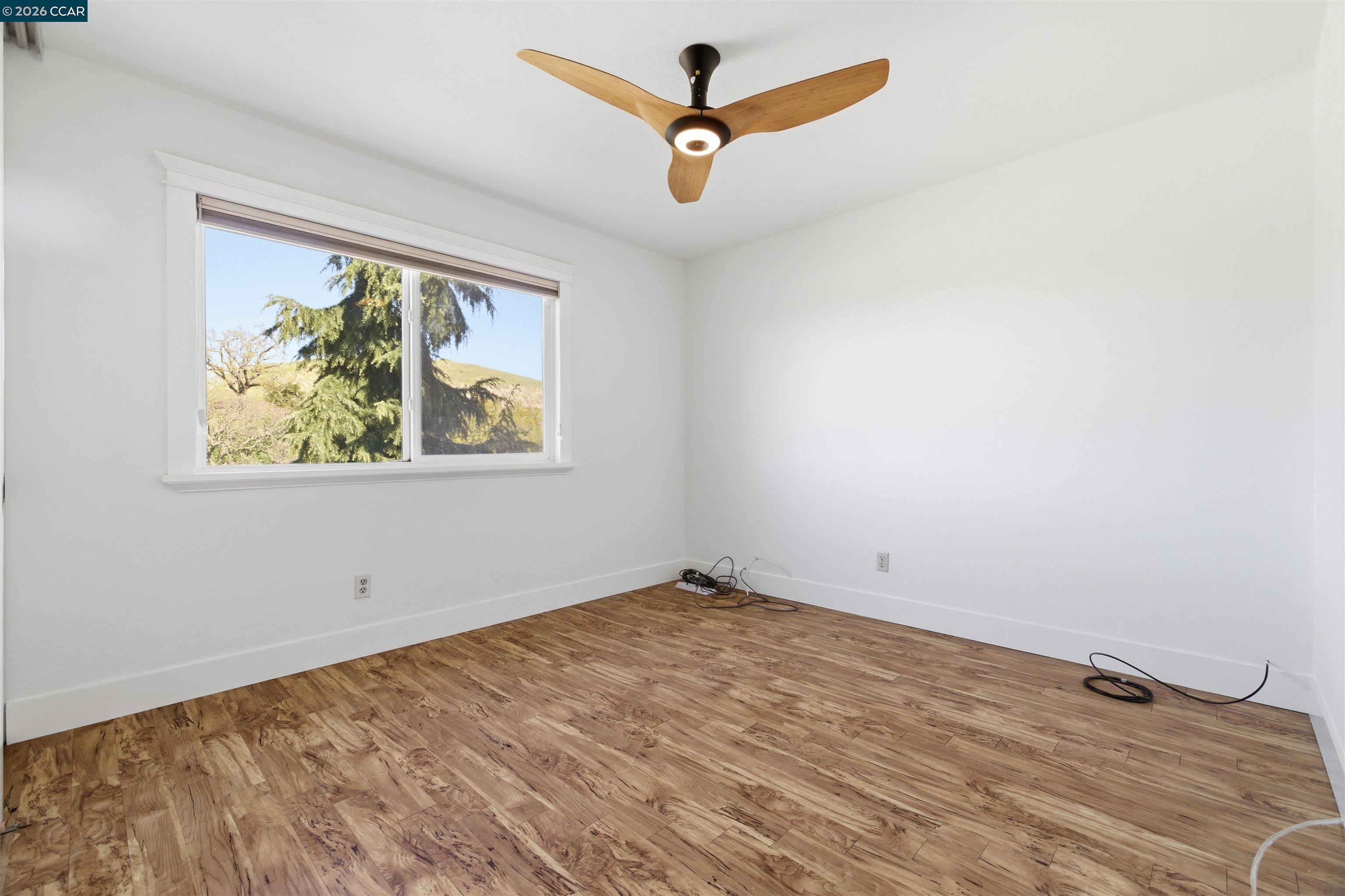 9530 Morgan Territory Road Livermore, CA 94551 - Photo 29 of 55 an empty room with a window and a ceiling fan