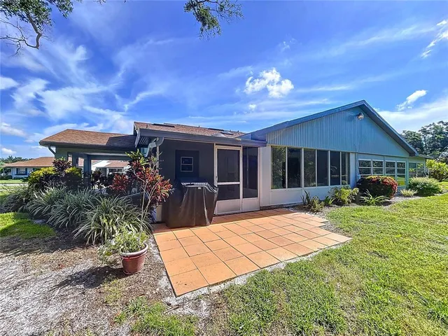a view of a house with backyard porch and sitting area