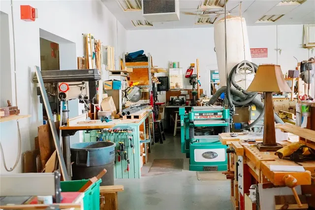 a view of a patio with table and chairs a barbeque with wooden fence and floor
