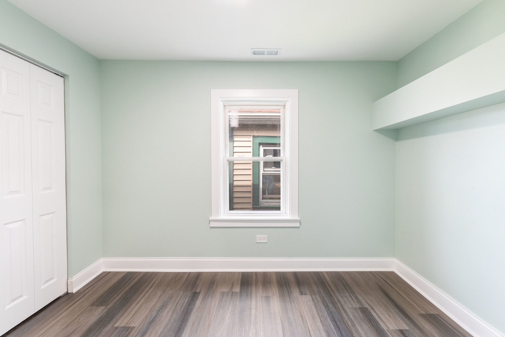 2027 West 18th Place, Unit 2 Chicago, IL 60608 - Photo 13 of 21 an empty room with wooden floor and windows