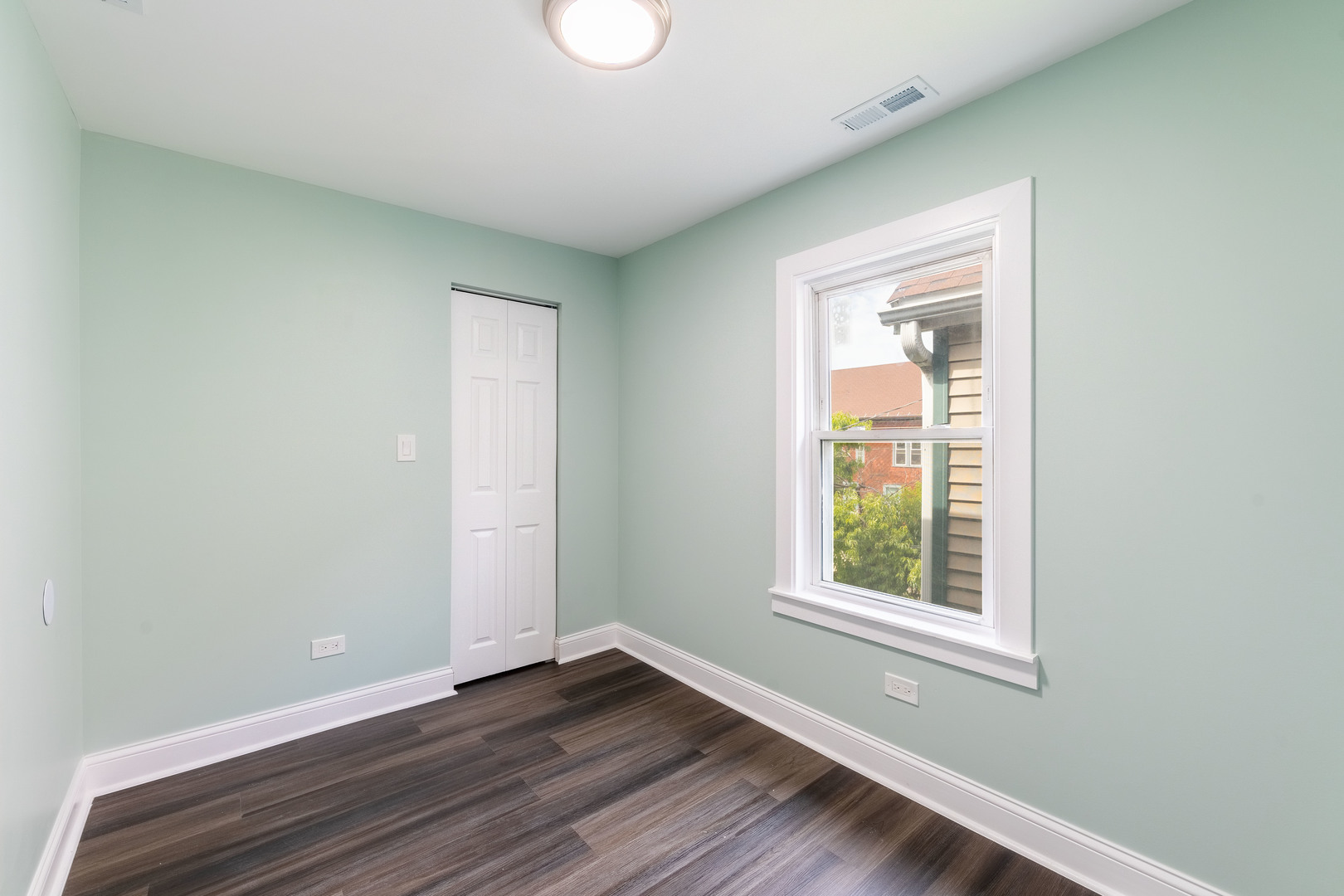 2027 West 18th Place, Unit 2 Chicago, IL 60608 - Photo 14 of 21 an empty room with wooden floor and windows