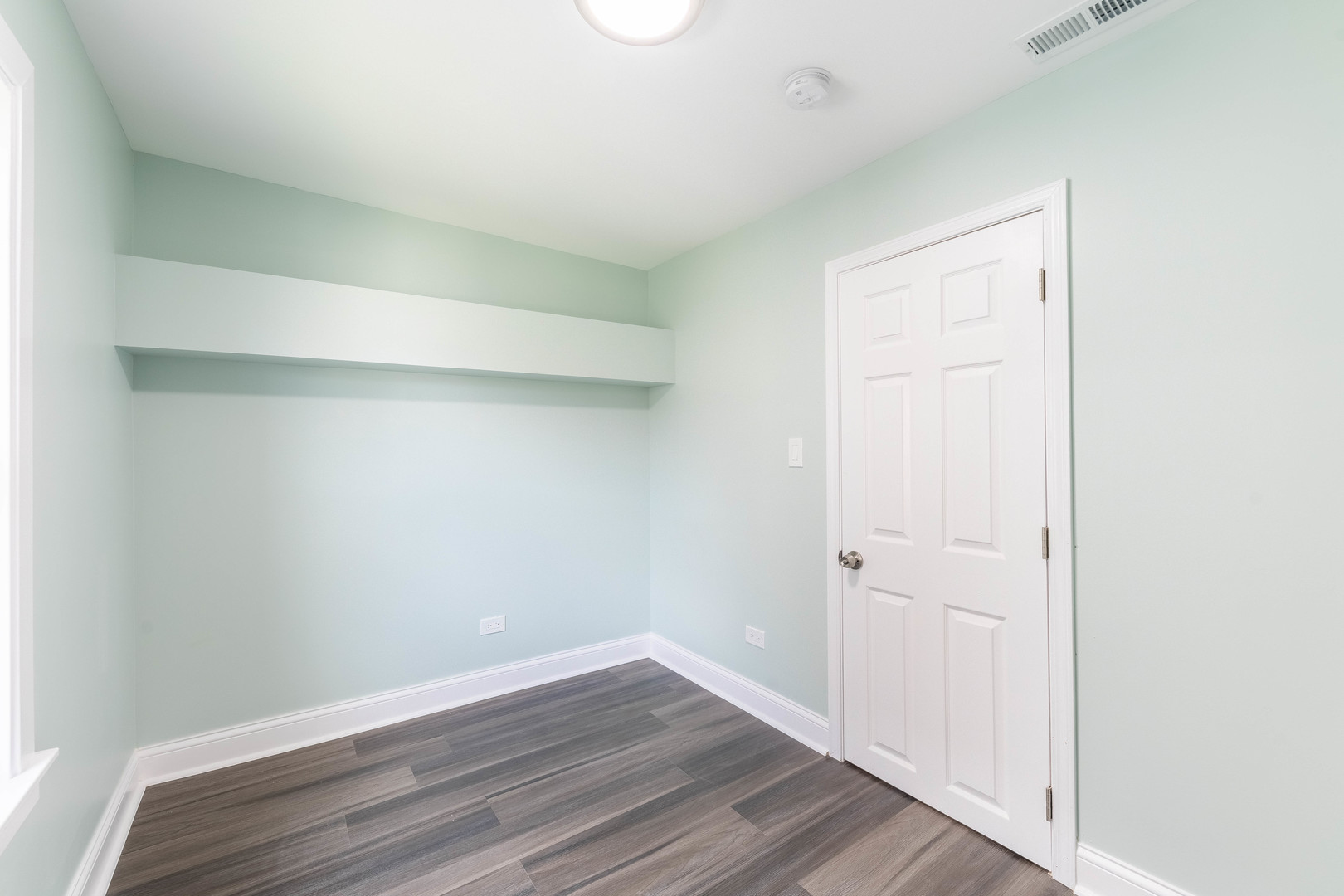 2027 West 18th Place, Unit 2 Chicago, IL 60608 - Photo 15 of 21 a view of an empty room with wooden floor