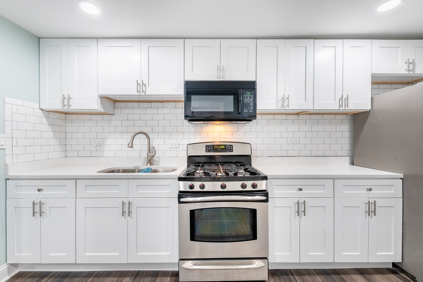 2027 West 18th Place, Unit 2 Chicago, IL 60608 - Photo 2 of 21 a kitchen with white cabinets and appliances