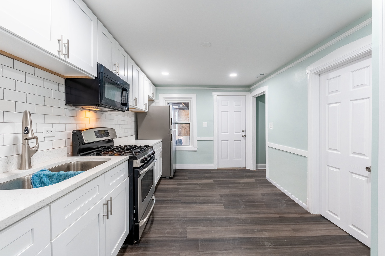 2027 West 18th Place, Unit 2 Chicago, IL 60608 - Photo 4 of 21 a large kitchen with a stove and a sink