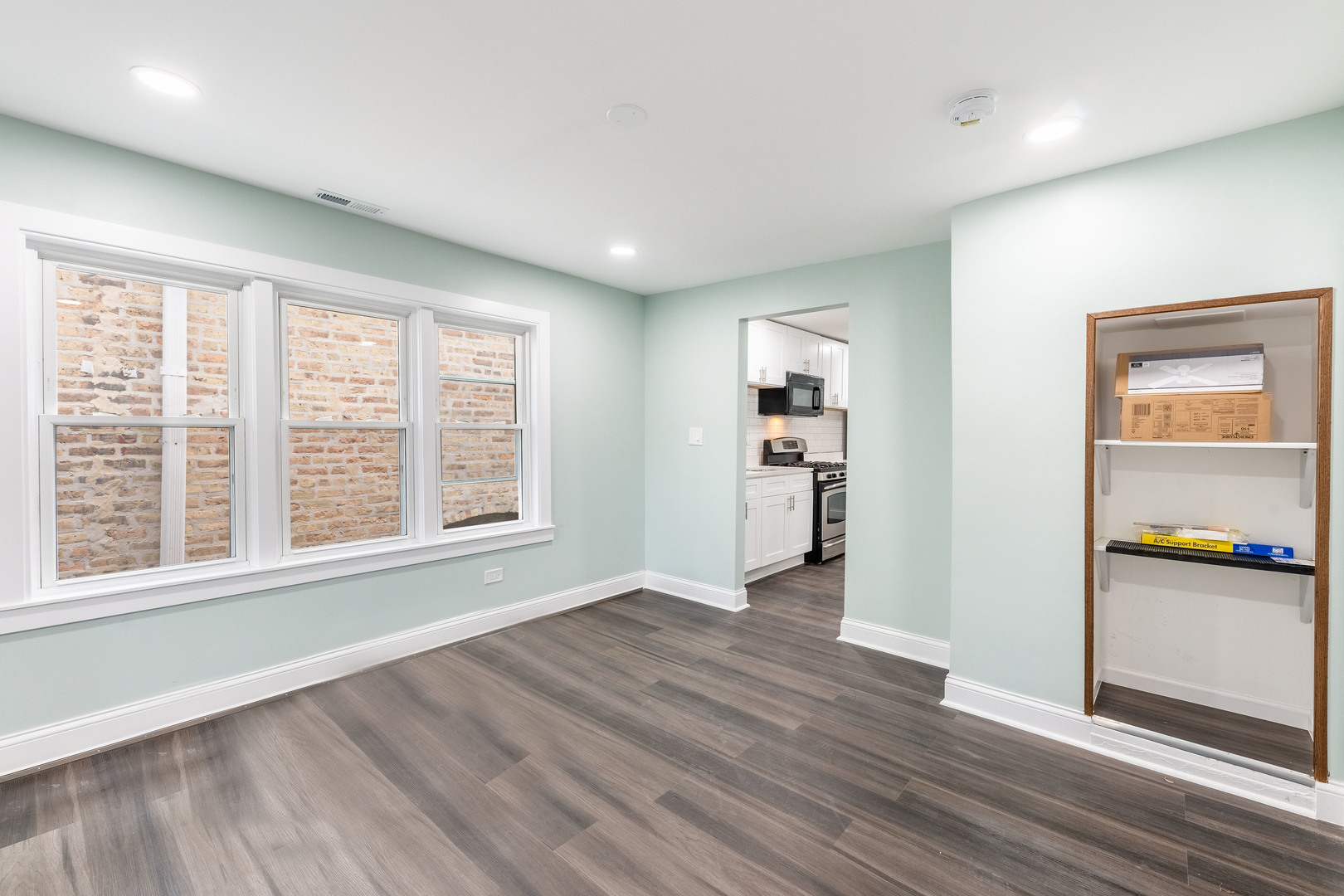 2027 West 18th Place, Unit 2 Chicago, IL 60608 - Photo 6 of 21 a view of empty room with wooden floor and kitchen view