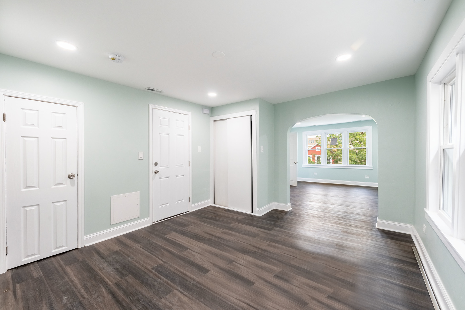 2027 West 18th Place, Unit 2 Chicago, IL 60608 - Photo 7 of 21 an empty room with wooden floor and windows