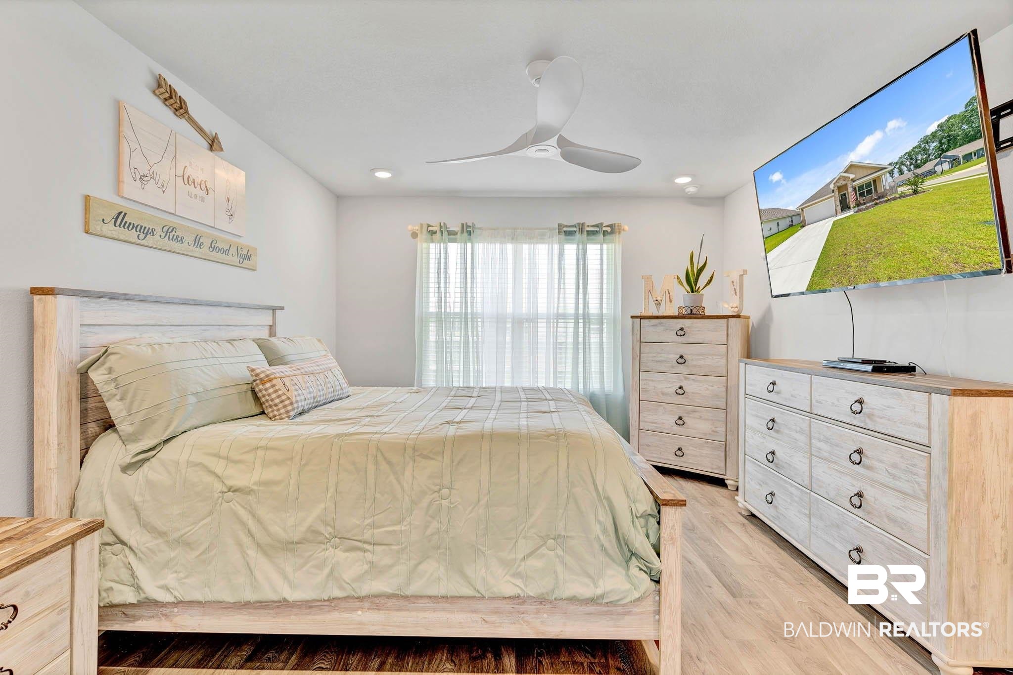 17217 REFLECTION Street Loxley, AL 36551 - Photo 21 of 83 Primary Bedroom off the great room with light wood lvp finished floors, a ceiling fan, and recessed lighting
