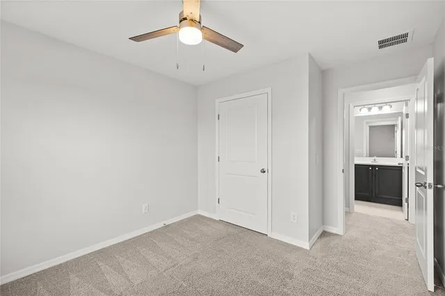 an empty room with a bathroom and a sink