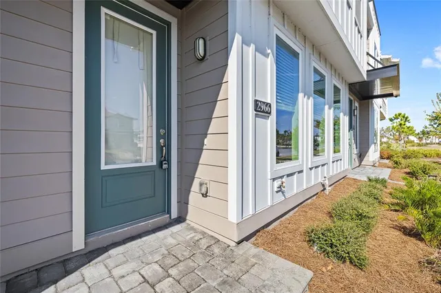 a view of a house with a small yard and wooden floor and fence