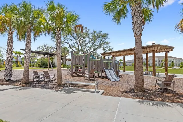 a view of a park with swings and slides