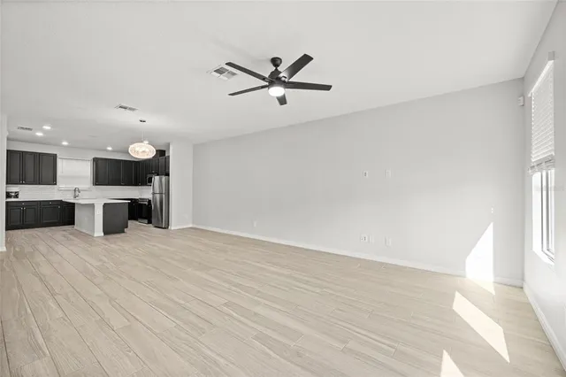 a view of a kitchen with a sink and a ceiling fan