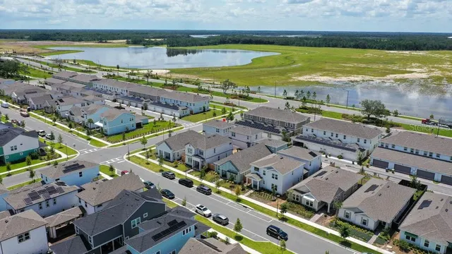 an aerial view of a city with a lake view