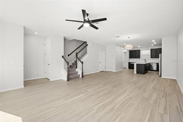 a view of a livingroom with a kitchen and a stove top oven