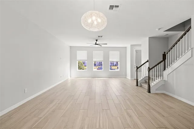 a view of livingroom with hardwood floor and a ceiling fan