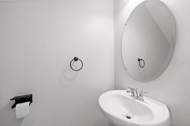 a bathroom with a sink and mirror
