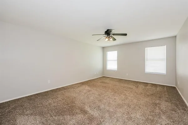 a view of an empty room with a fan