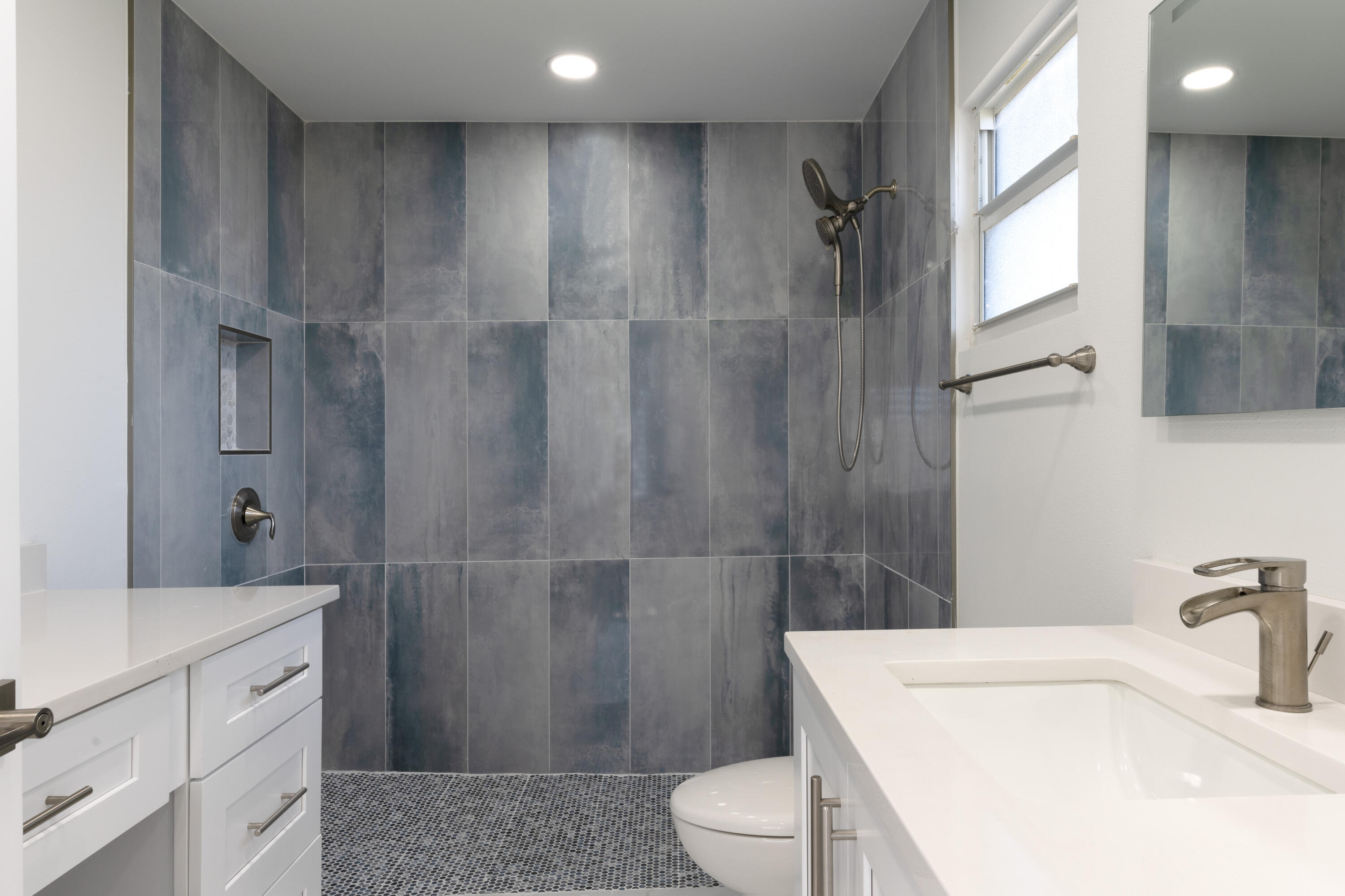 13757 Cocoanut Avenue Juno Beach, FL 33408 - Photo 13 of 31 a bathroom with a sink a toilet and shower