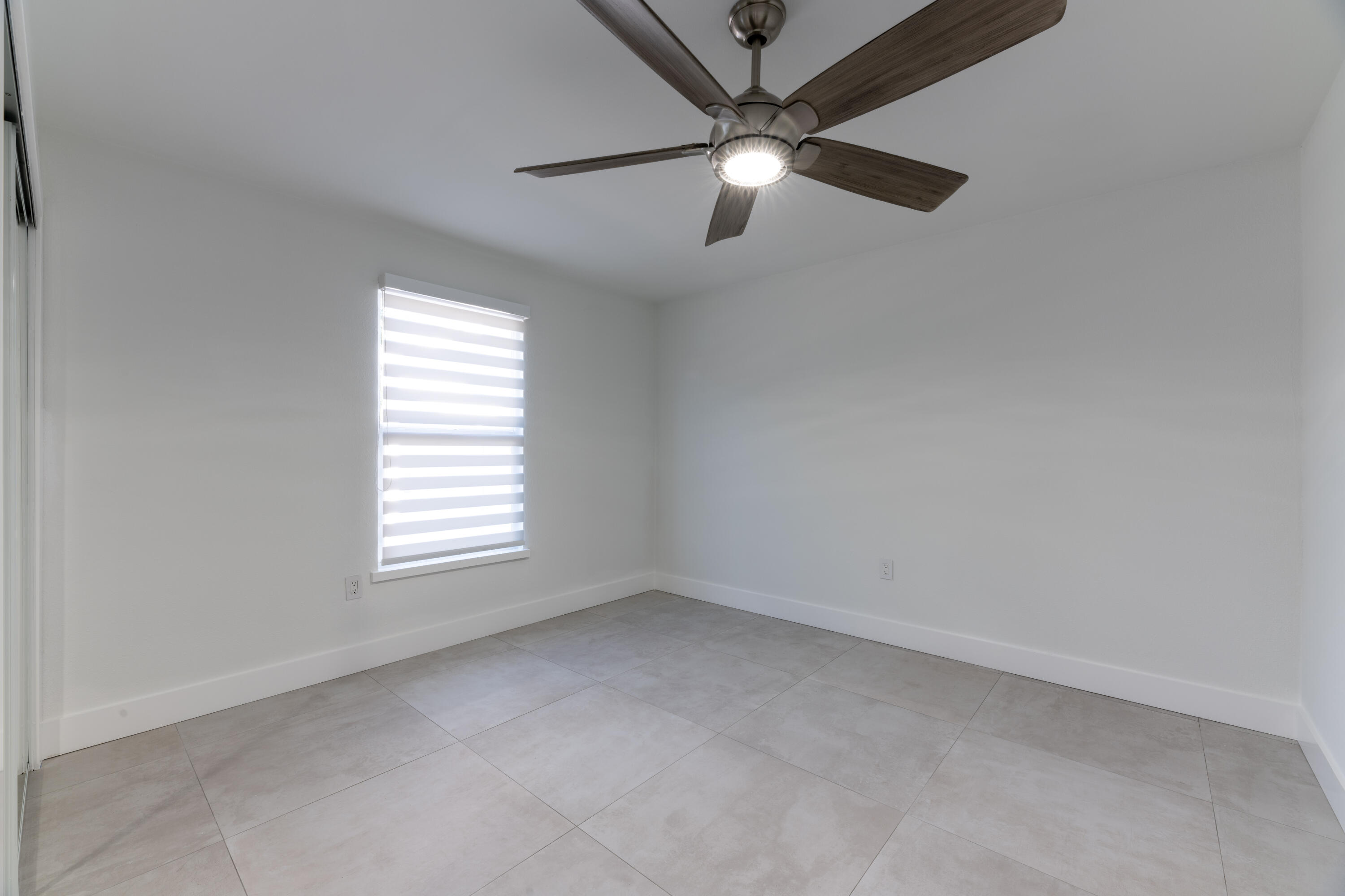13757 Cocoanut Avenue Juno Beach, FL 33408 - Photo 16 of 31 an empty room with a window
