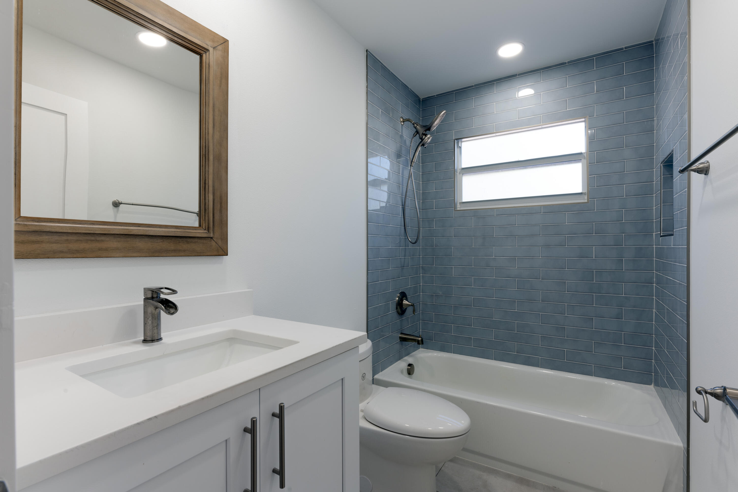 13757 Cocoanut Avenue Juno Beach, FL 33408 - Photo 17 of 31 a bathroom with a sink toilet a bathtub and shower
