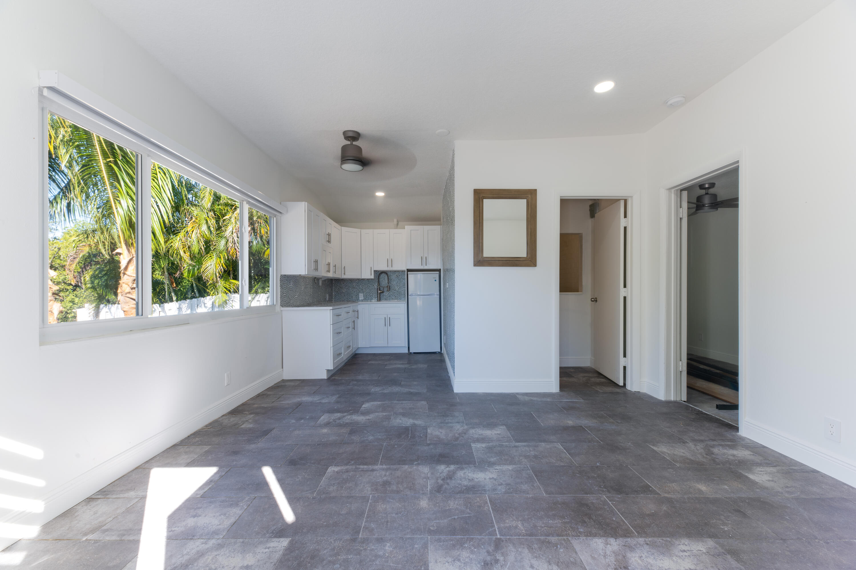 13757 Cocoanut Avenue Juno Beach, FL 33408 - Photo 21 of 31 a view of a kitchen with a refrigerator cabinets and a window