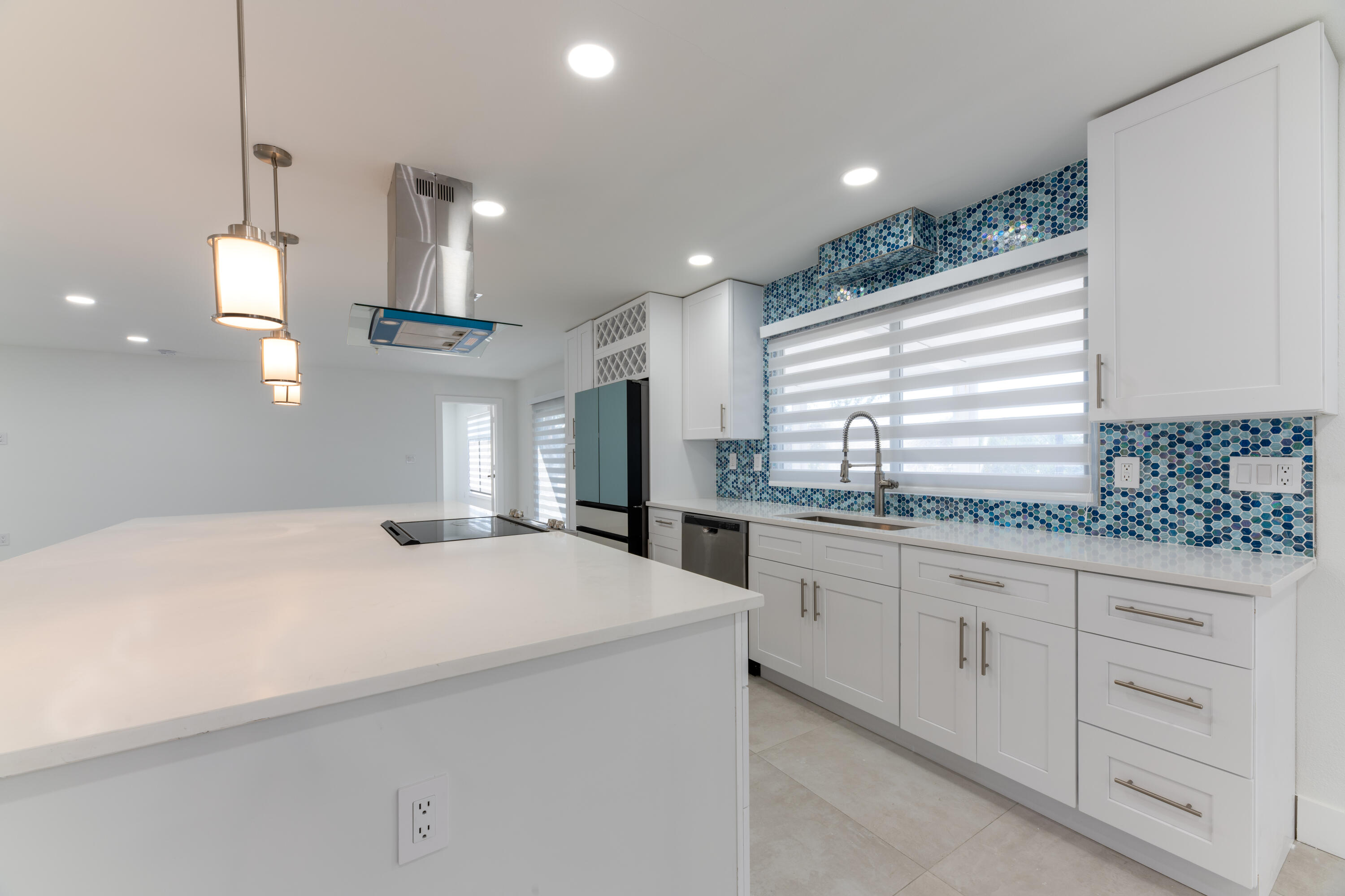 13757 Cocoanut Avenue Juno Beach, FL 33408 - Photo 5 of 31 a kitchen with granite countertop white cabinets and white appliances