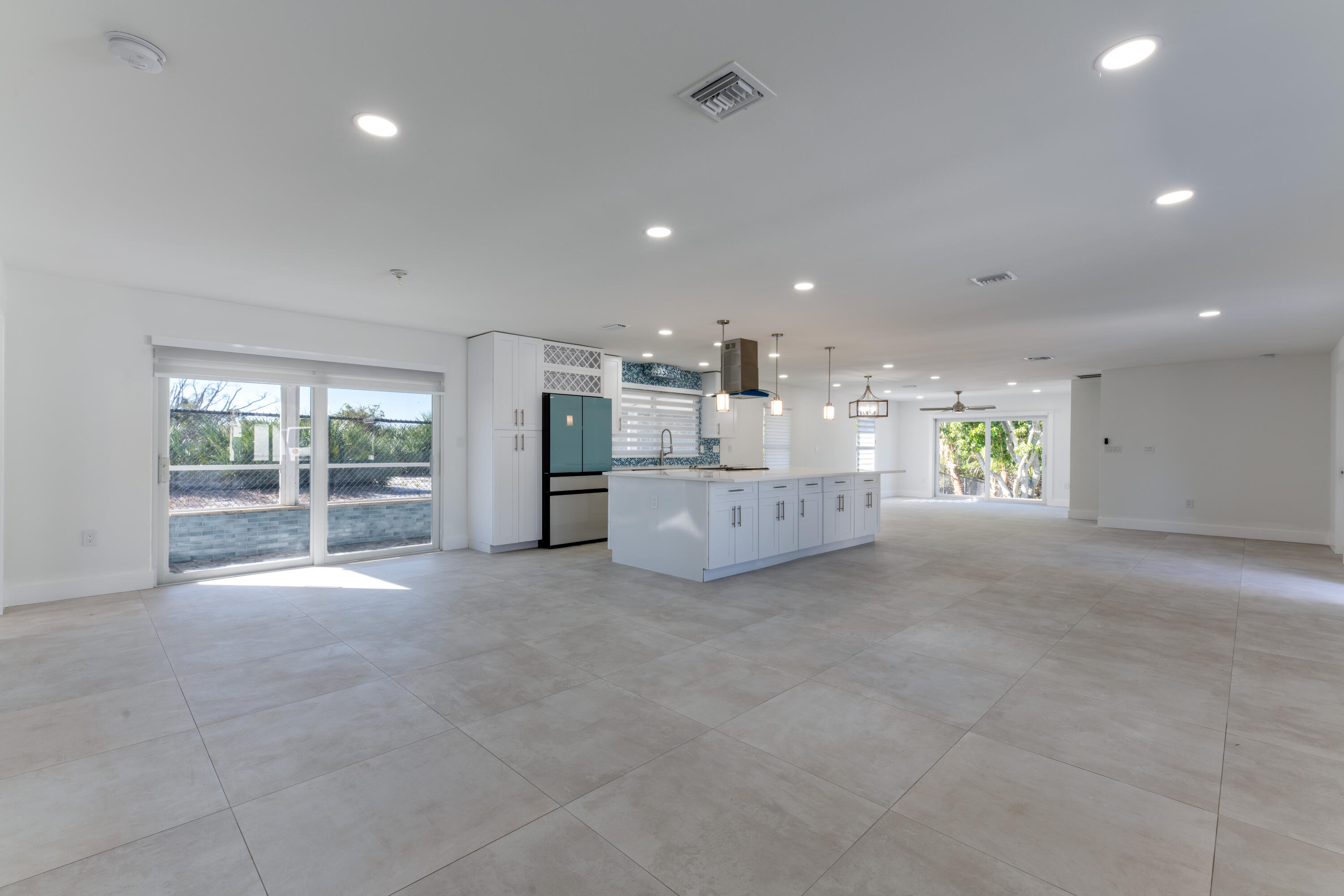 13757 Cocoanut Avenue Juno Beach, FL 33408 - Photo 6 of 31 a view of an empty room with a fireplace and a large window