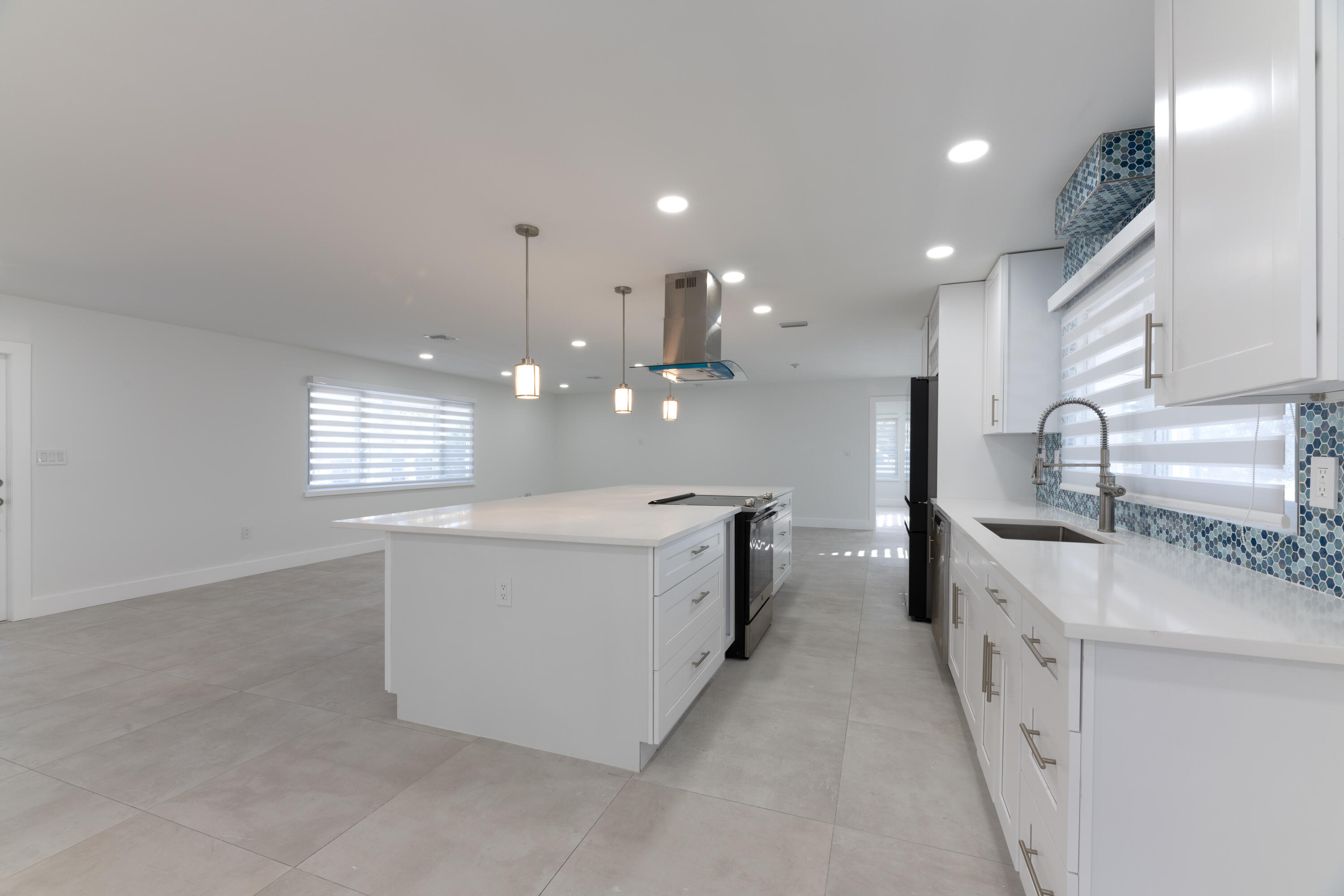 13757 Cocoanut Avenue Juno Beach, FL 33408 - Photo 7 of 31 a large white kitchen with lots of counter space