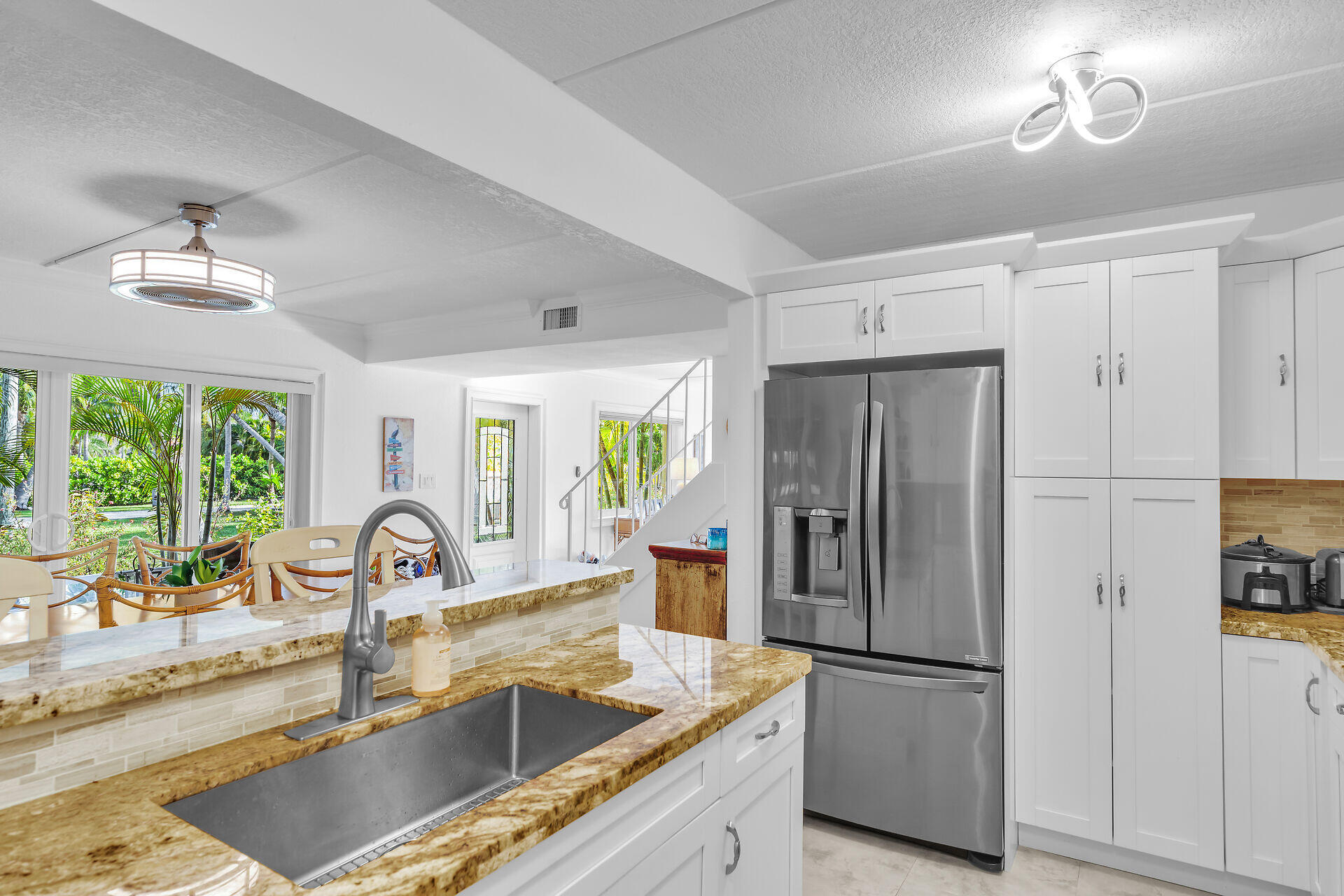 591 Sombrero Beach Road, Unit 8B Marathon, FL 33050 - Photo 16 of 43 a kitchen with refrigerator cabinets and a sink