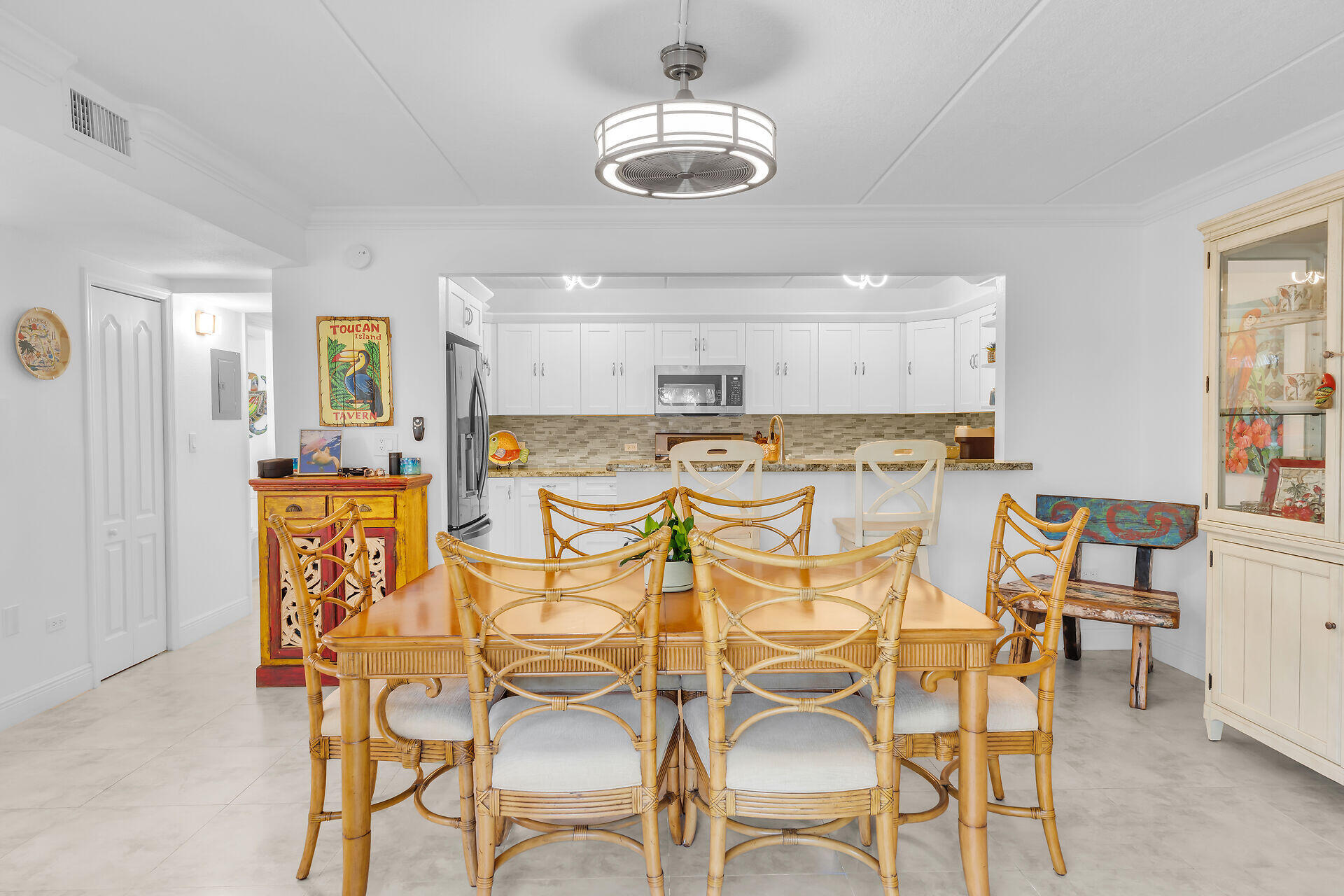 591 Sombrero Beach Road, Unit 8B Marathon, FL 33050 - Photo 17 of 43 a view of a dining room with furniture and chandelier