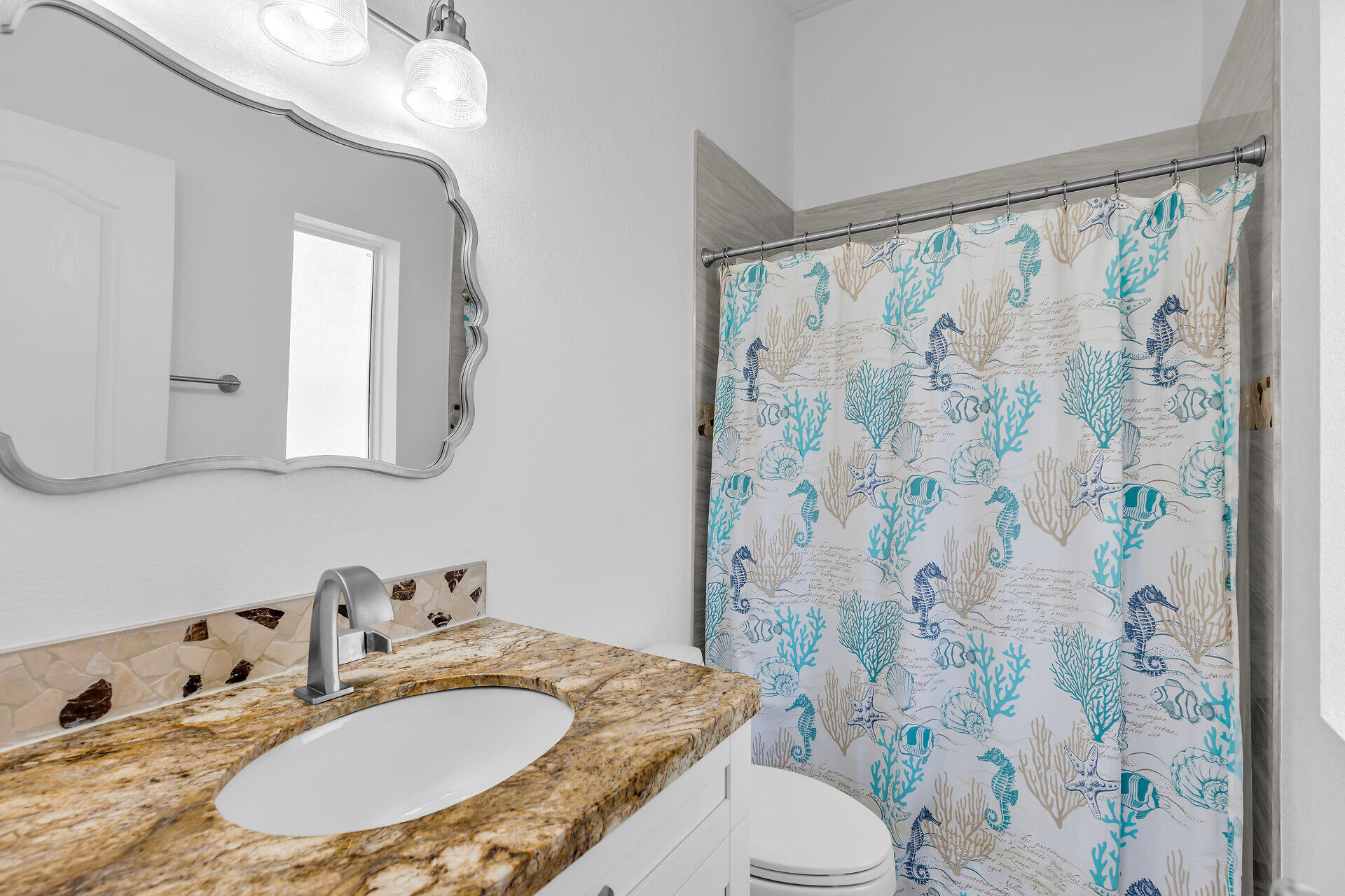 591 Sombrero Beach Road, Unit 8B Marathon, FL 33050 - Photo 20 of 43 a bathroom with a sink and a mirror