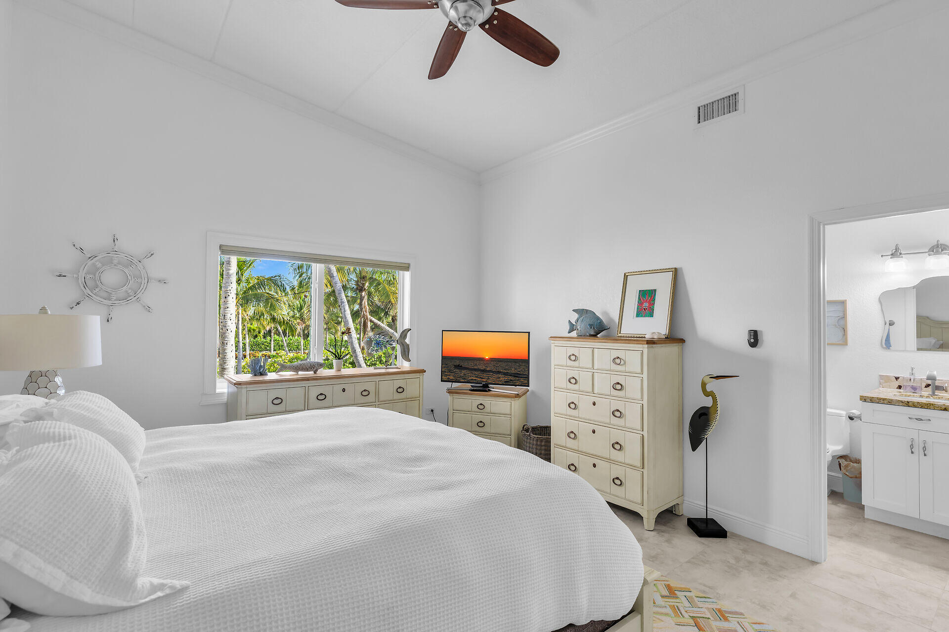 591 Sombrero Beach Road, Unit 8B Marathon, FL 33050 - Photo 28 of 43 a spacious bedroom with a bed and a chandelier