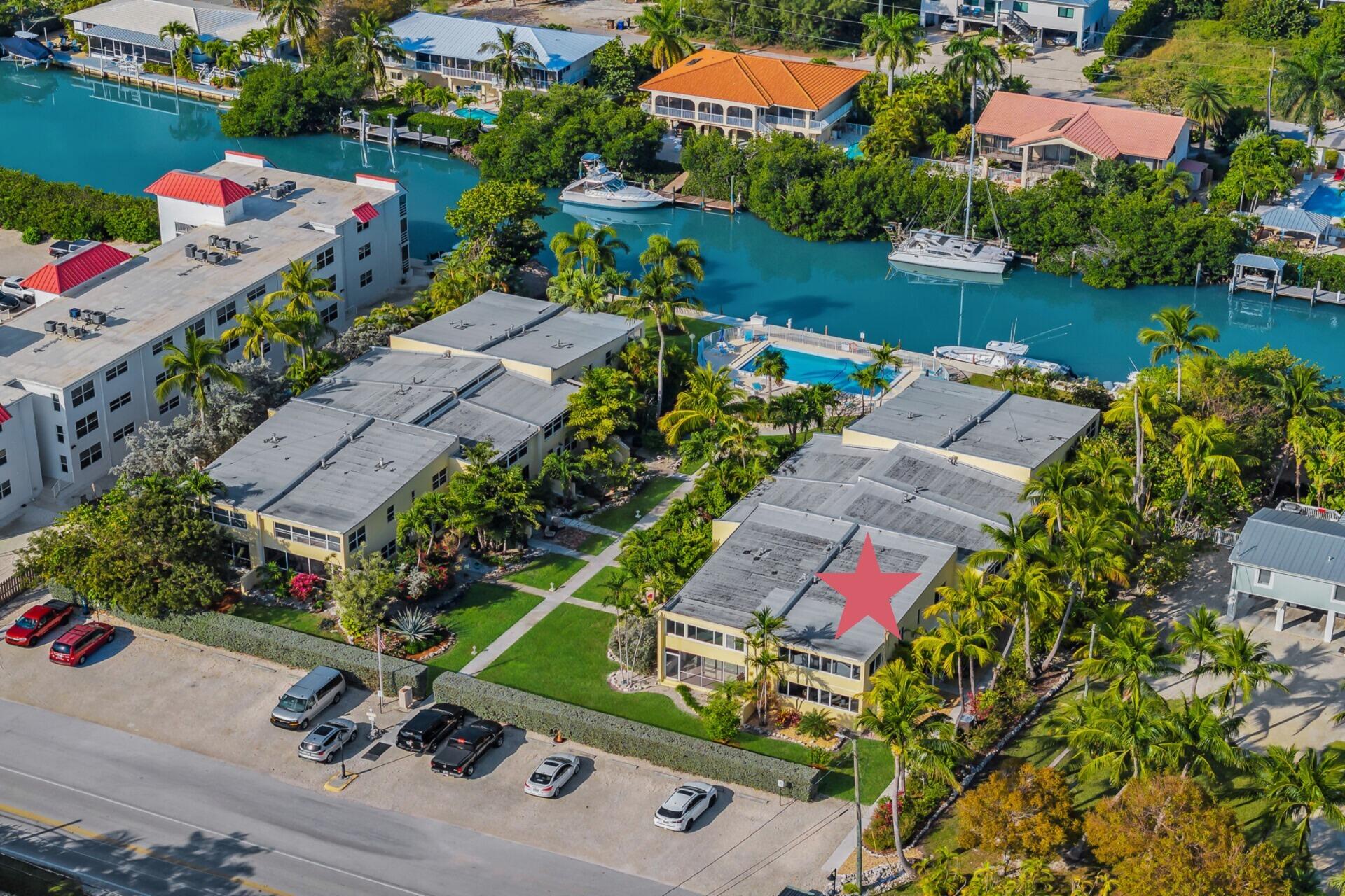591 Sombrero Beach Road, Unit 8B Marathon, FL 33050 - Photo 3 of 43 an aerial view of a house with a lake view