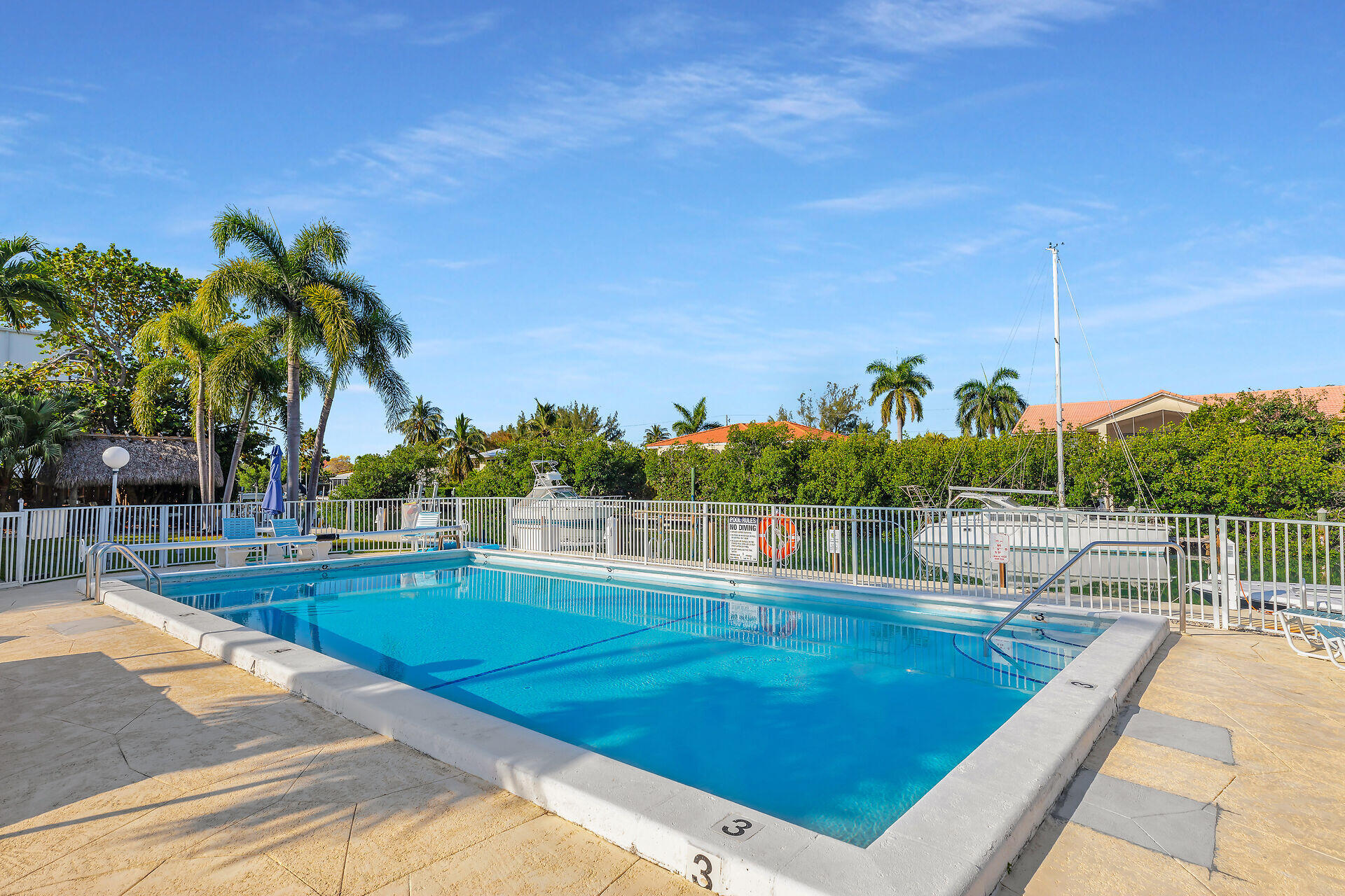 591 Sombrero Beach Road, Unit 8B Marathon, FL 33050 - Photo 32 of 43 a view of a swimming pool with a lounge chair