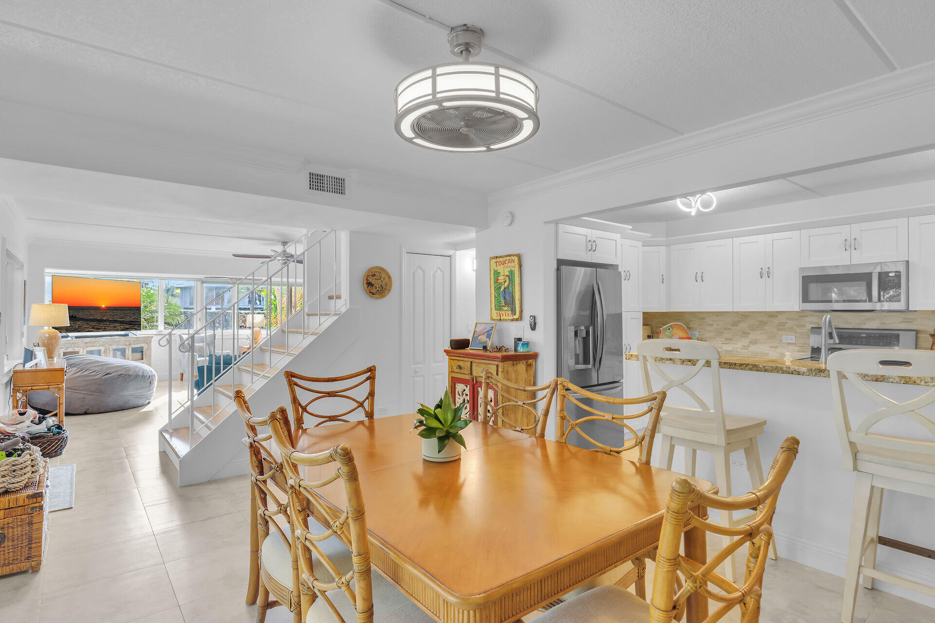 591 Sombrero Beach Road, Unit 8B Marathon, FL 33050 - Photo 35 of 43 a dining room with stainless steel appliances furniture a rug and a kitchen view