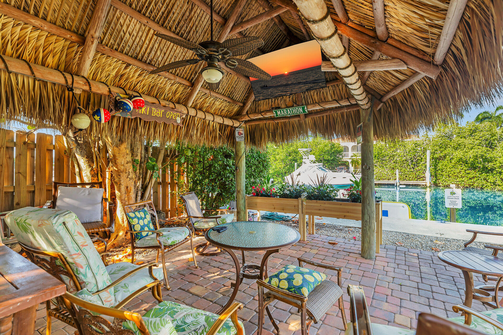 591 Sombrero Beach Road, Unit 8B Marathon, FL 33050 - Photo 42 of 43 a patio with a yard table and chairs