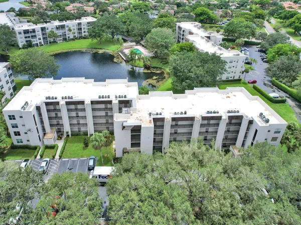 an aerial view of a house with a yard and lake view