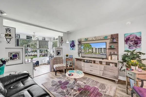 a living room with furniture and a chandelier