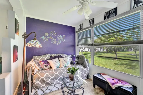a bedroom with a bed and ceiling fan