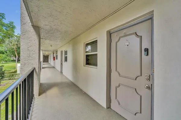 a view of a hallway with a white stove and a wooden floor