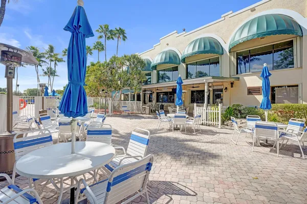 a view of swimming pool with outdoor seating and lake