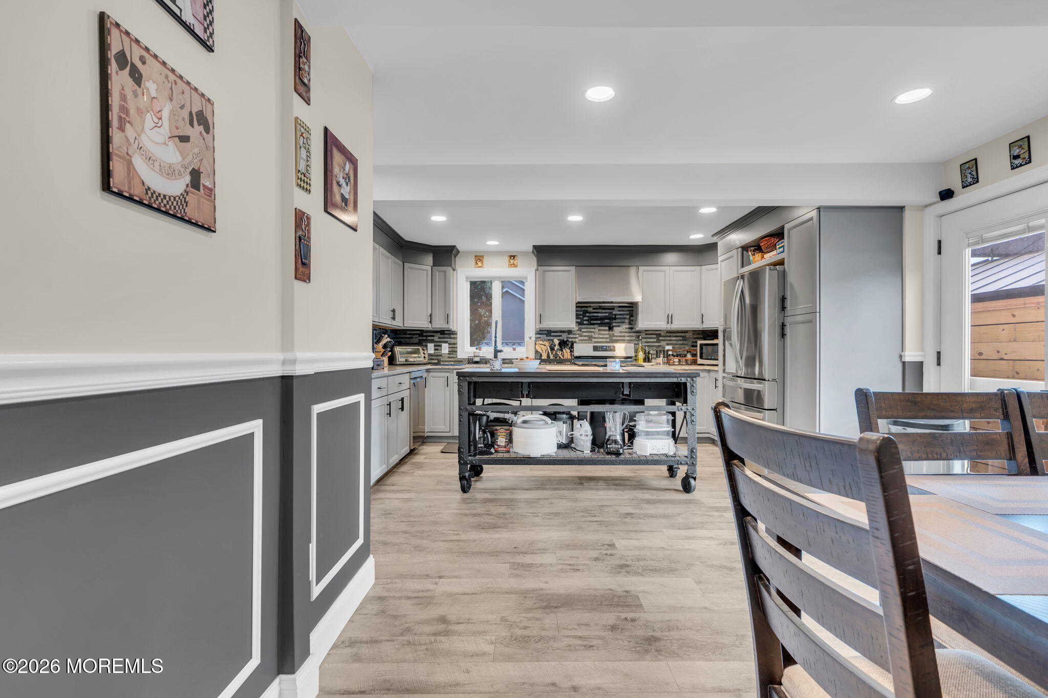 181 Locust Avenue Howell, NJ 07731 - Photo 22 of 66 a kitchen with stainless steel appliances kitchen island granite countertop a refrigerator a stove a sink dishwasher and white cabinets with wooden floor