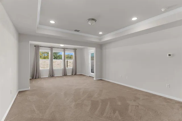 a view of an empty room with large windows