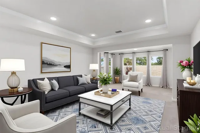 a living room with furniture and large windows