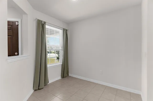 a view of a dining room with a table and chairs