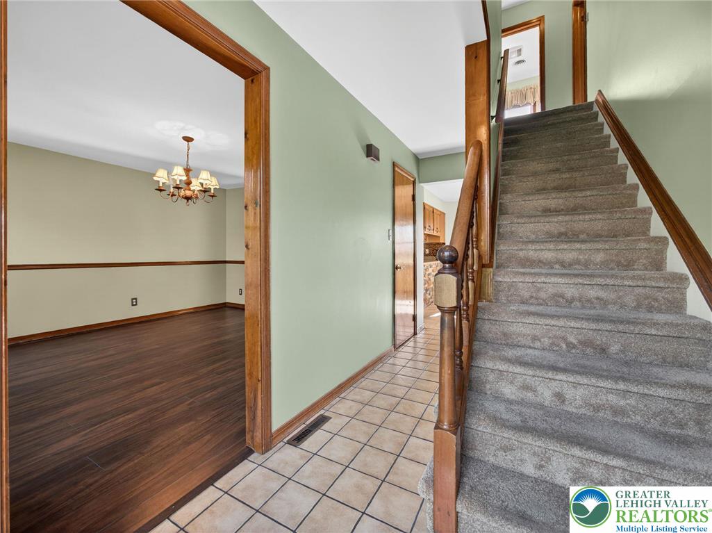 7098 Limerick Square Bath, PA 18014 - Photo 5 of 31 a view of a hallway with wooden floor and staircase