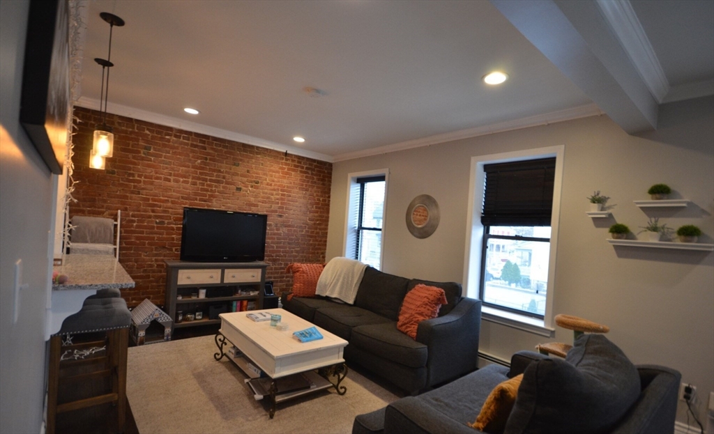 60 Florida Street, Unit 2 Boston, MA 02124 - Photo 1 of 25 a living room with furniture and a flat screen tv