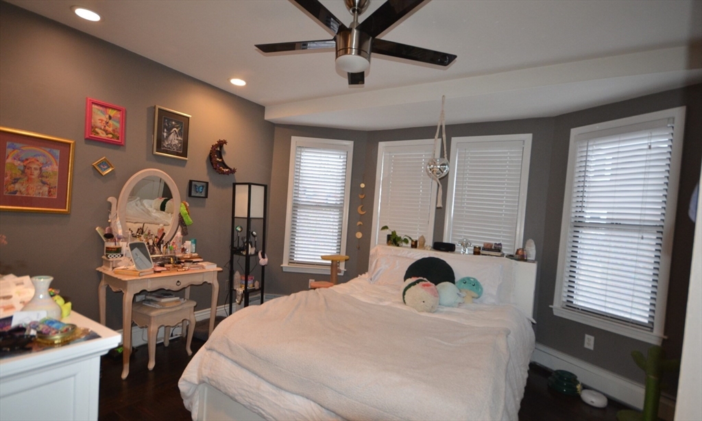 60 Florida Street, Unit 2 Boston, MA 02124 - Photo 12 of 25 a bedroom with a bed and a chandelier